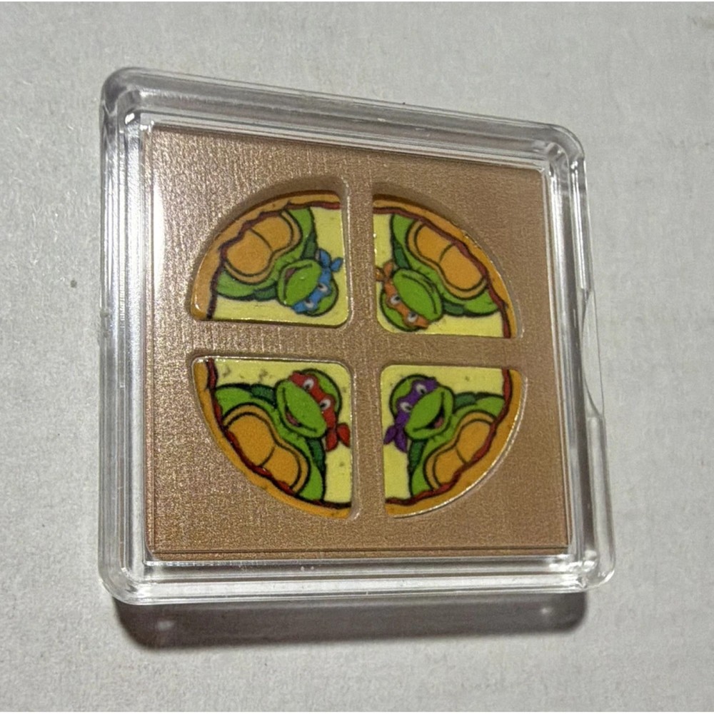 4g Silver Teenage Mutant Ninja Turtles in Pizza Shaped capsule.